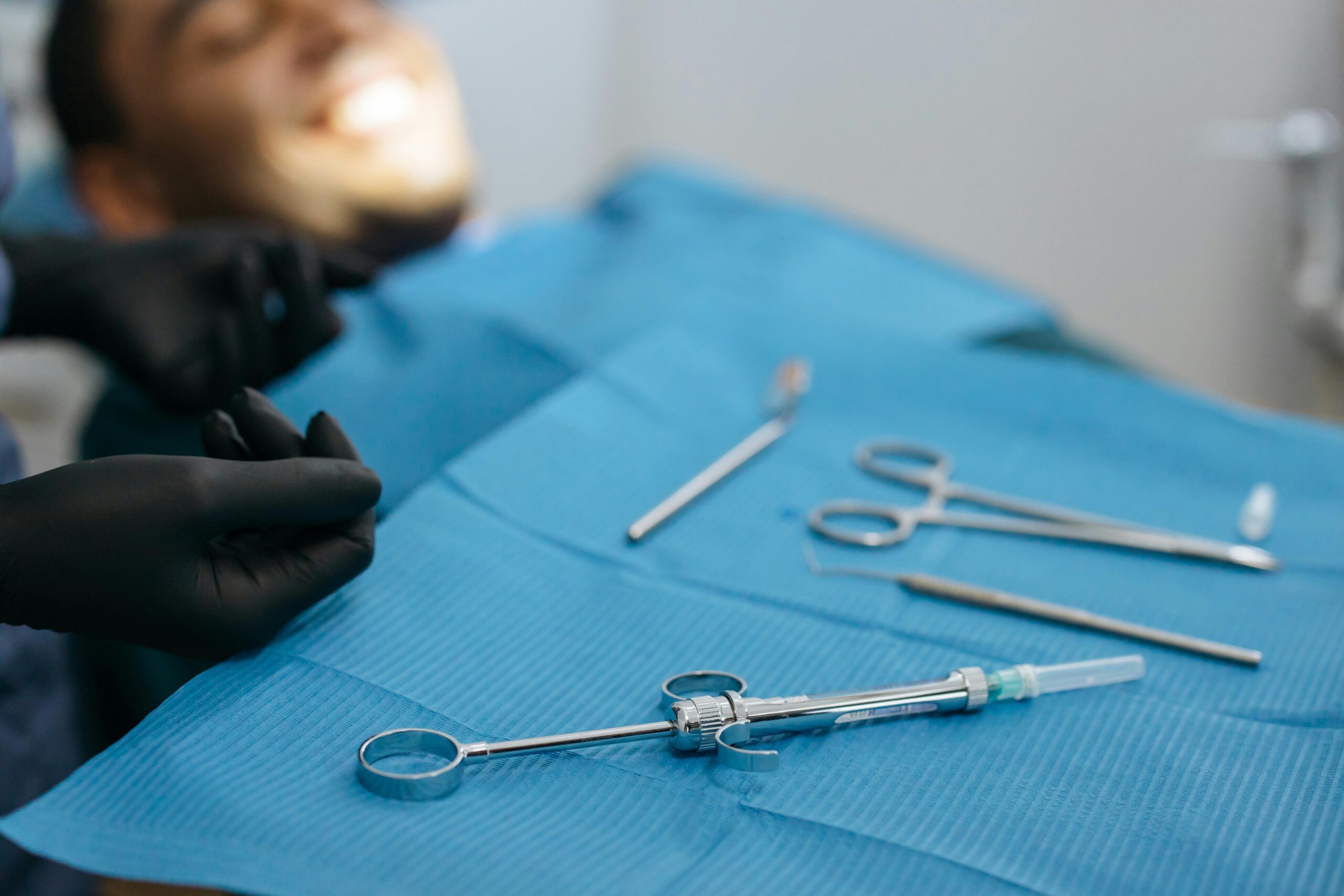 Dental tools arranged neatly on a blue dental cloth. Ideal for dental care concepts.