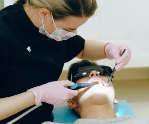Dentist performing a dental check-up on a patient in a clinic, ensuring oral health.
